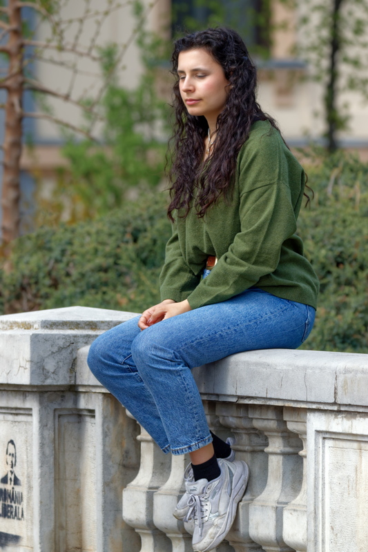Girl sitting on a stone fence